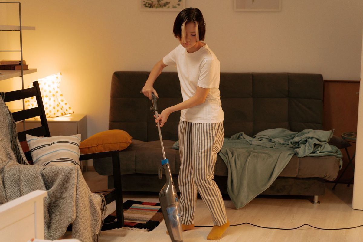 Cleaner organizing a bright Edmonton apartment living area